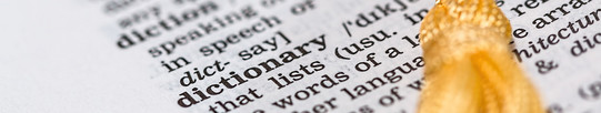 An open page of an english dictionary with a yellow bookmark.